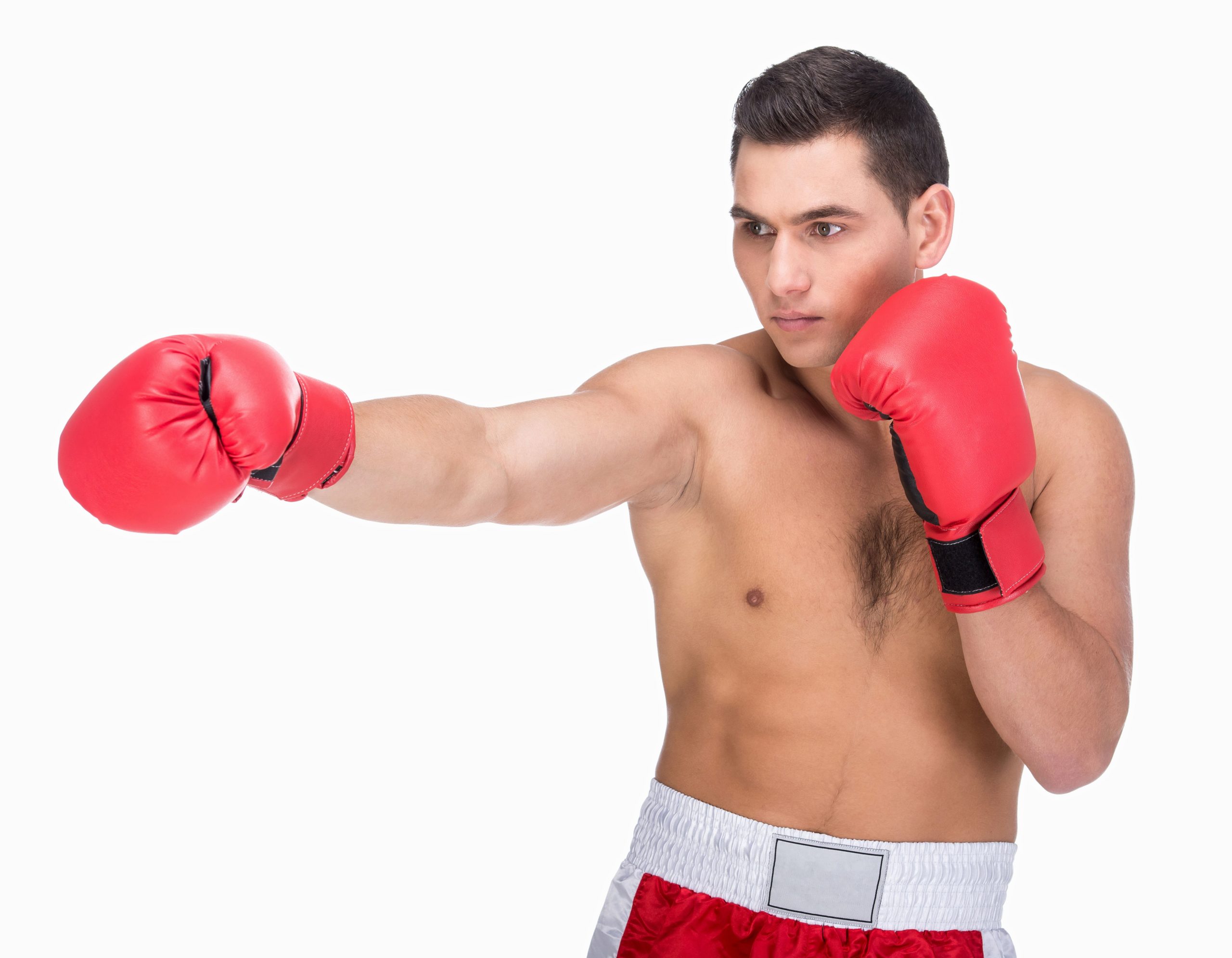 Muscular young man with boxing gloves reaching ahead