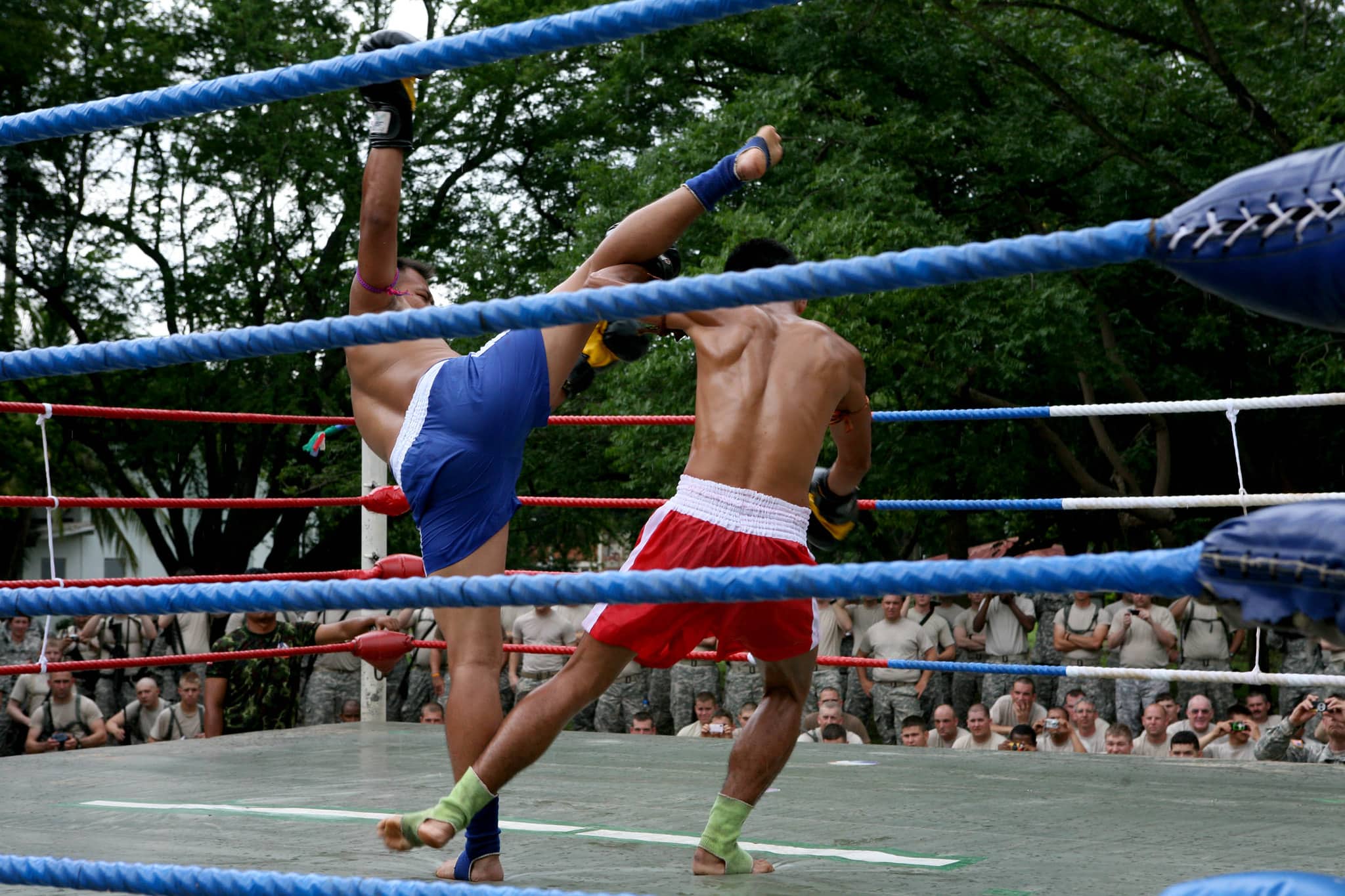 attempts a high roundhouse kick, which was blocked by (Name) and answered with an awe-inspiring and painful leg sweep at a Muay Thai demonstration