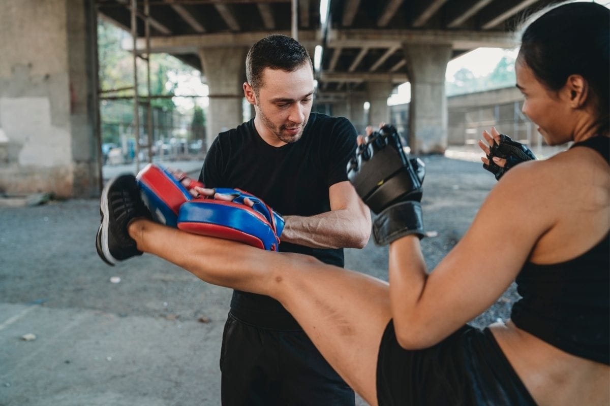 man and woman training for muay thai